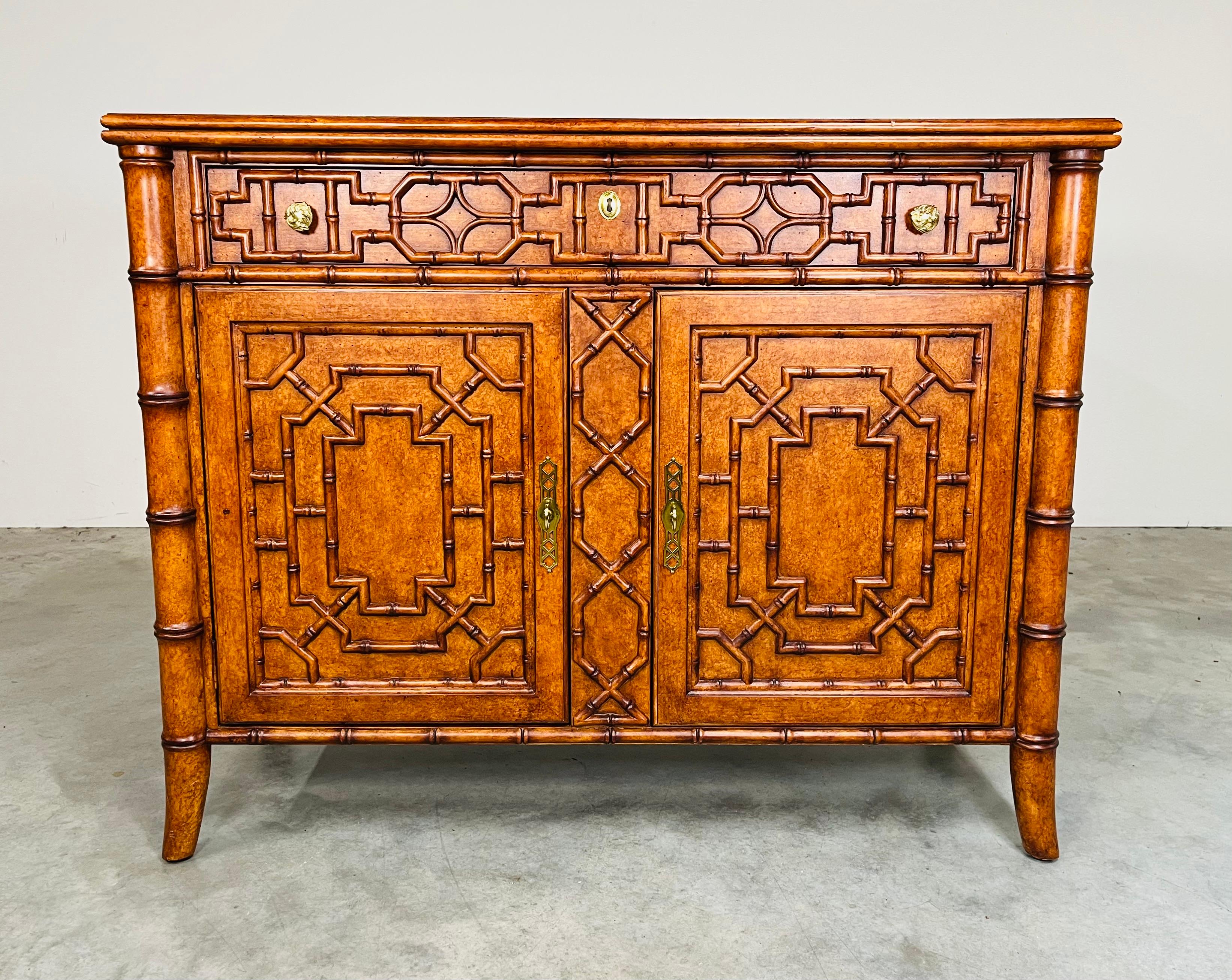 A stunning faux bamboo buffet or server having cabriole legs under a faux tortoise top by Maitland Smith. The details are outstanding throughout with elegant brass pulls that open the cabinet doors to ample storage with a height adjustable shelf