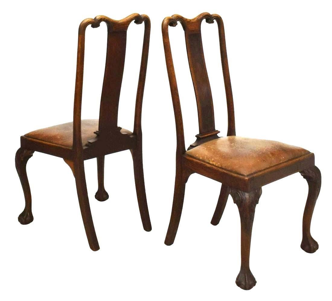 Set of six vintage Chippendale style oak dining chairs, early 20th c. Each chair features a shaped toprail with scrolled carving, burlwood center splat, over leather seat, foliate carved knees, ending in claw-and-ball feet.

Dimensions
approx 42