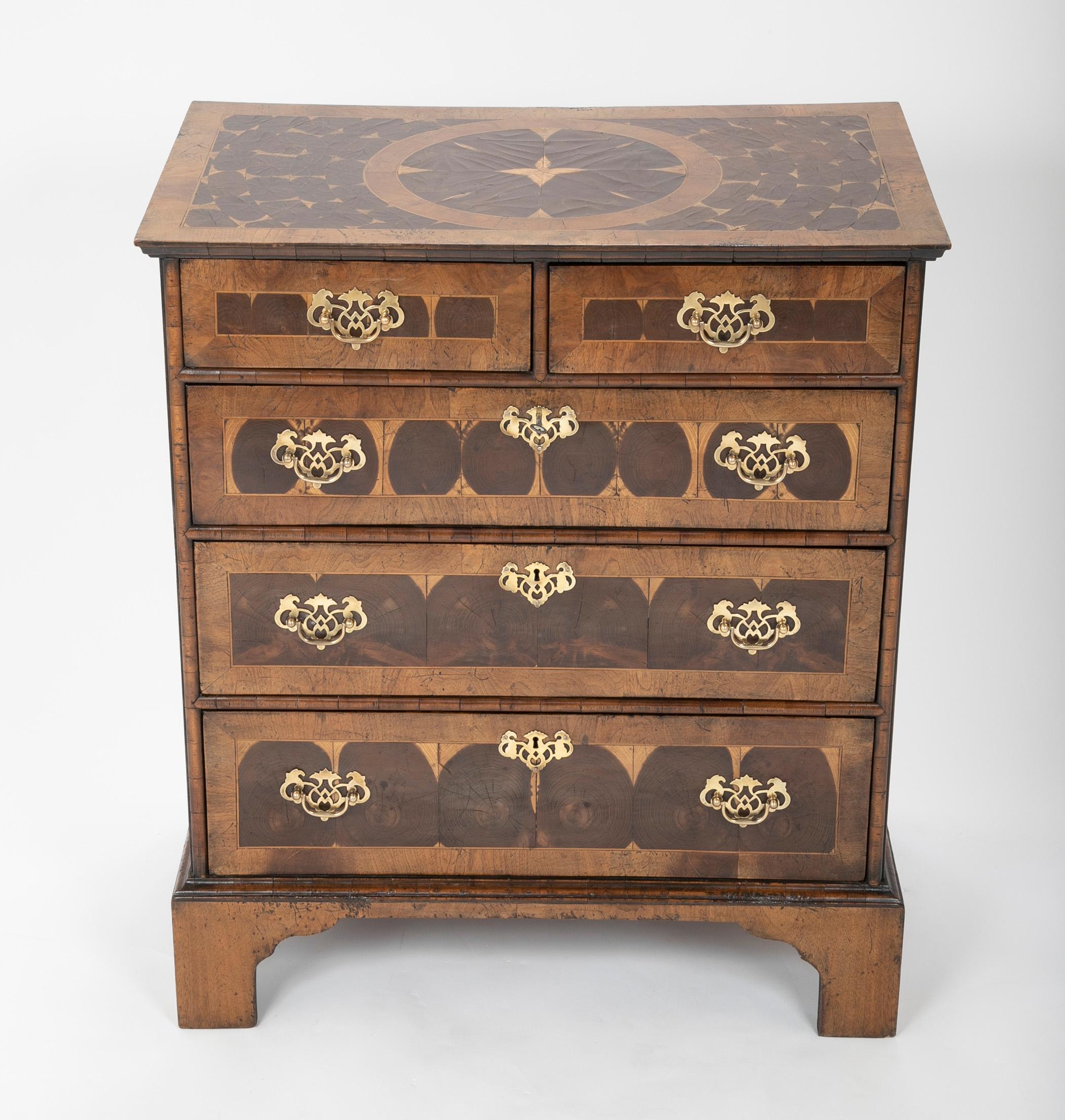 A very handsome antique chest of drawers with stunning oyster veneer and pierced brass hardware. The perfect size for an apartment, or a wonderful and useful accent piece for any home. This is the item people will ask about when they step into your