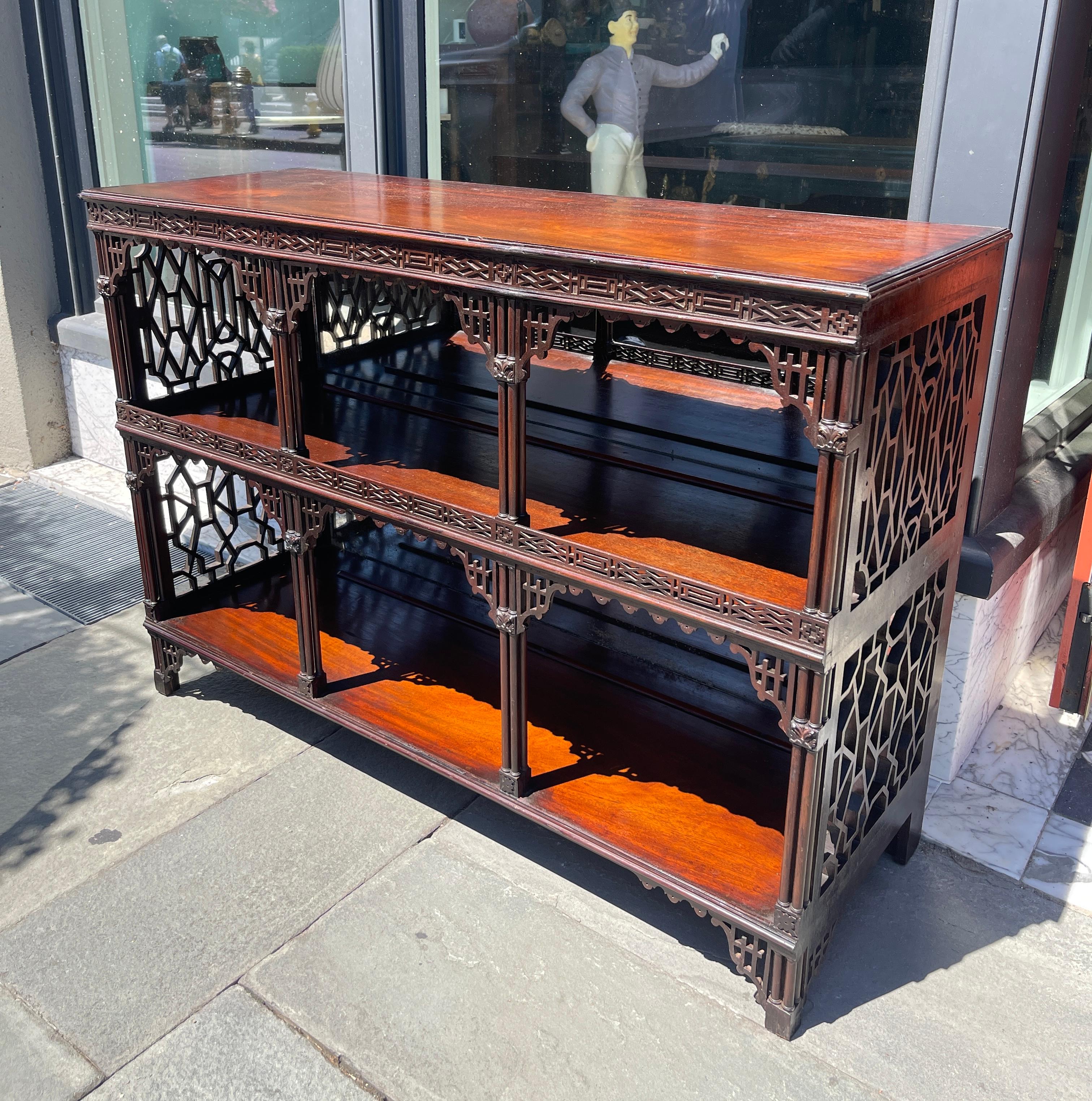Open cabinet with elaborate fret work in the Chippendale style. Mirrored back with plate rail for display. Mid 19th century 