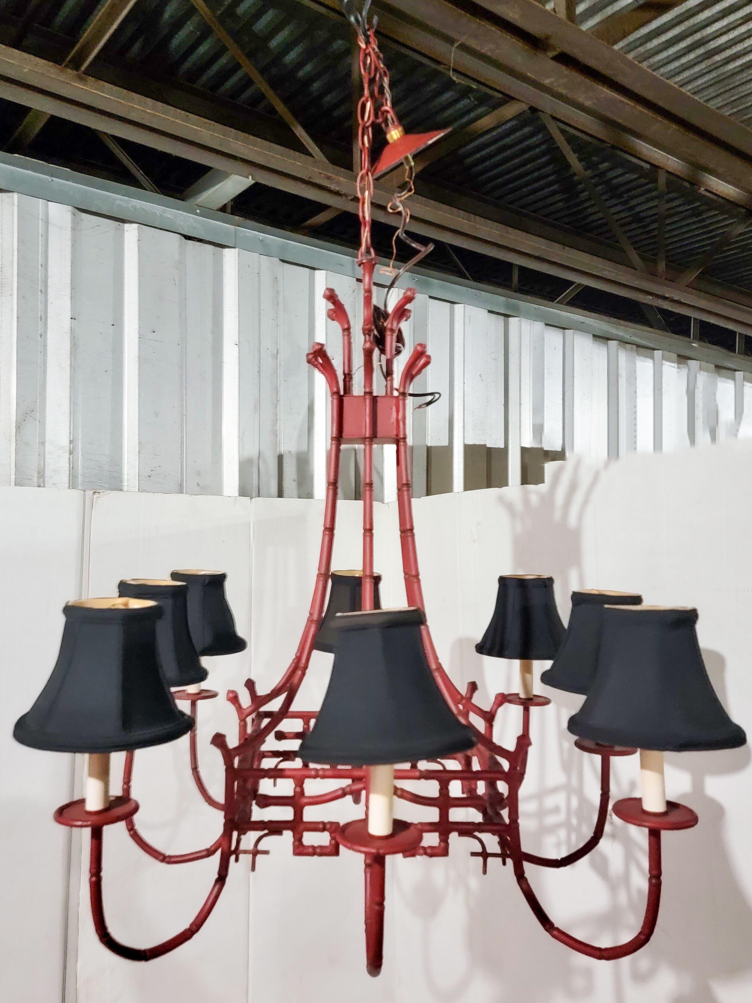 Wonderful and just in time for the holidays! This is a Regency style red tole painted faux bamboo pagoda form chandelier in very good condition. It is UL listed and has about 16” of chain.
