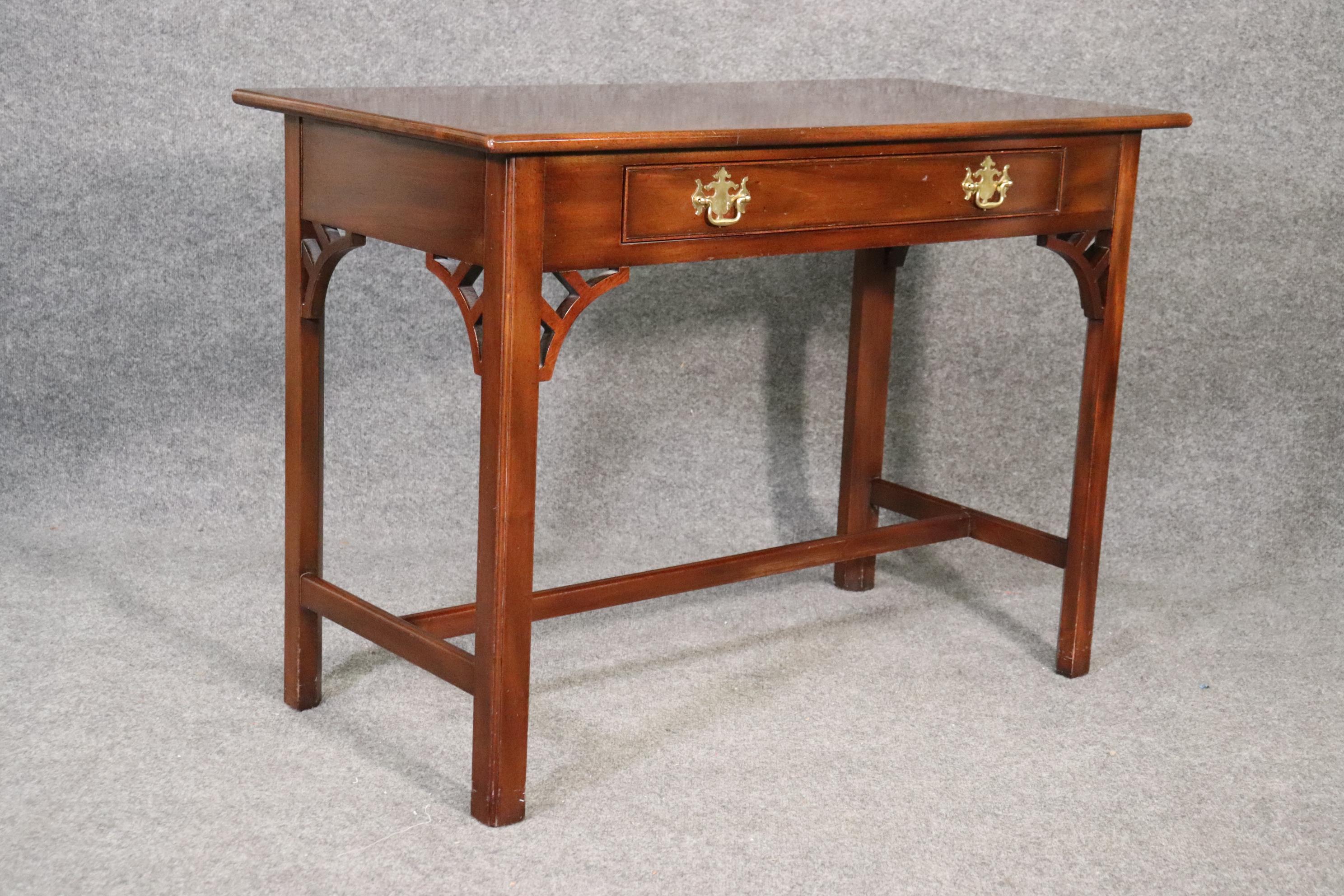 This is one of the more distinguished collections by Kittinger and is solid mahogany and designed in the Chippendale style. The desk measures 42 wide x 30 tall x 21 deep.