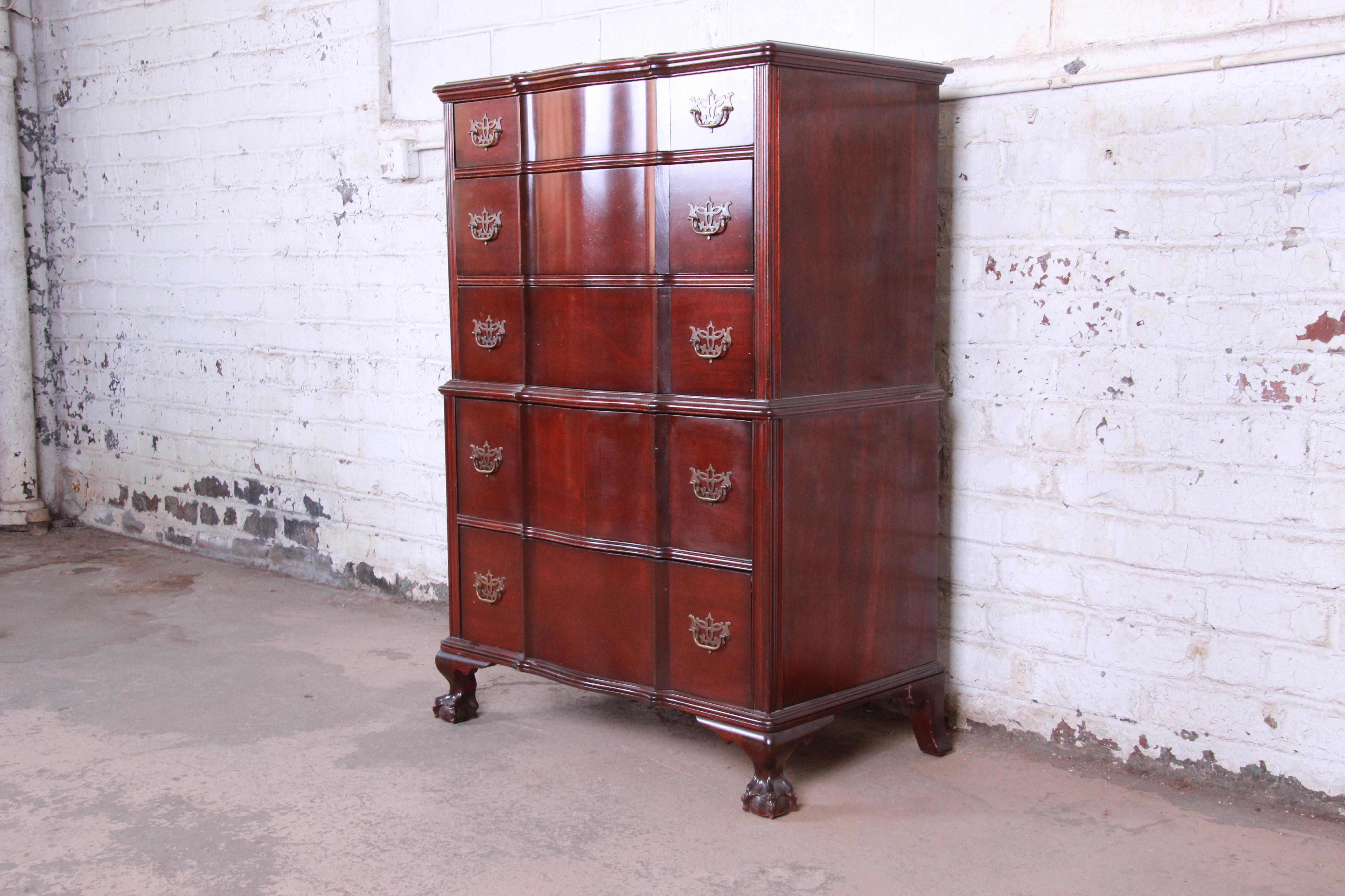 A beautiful solid mahogany Chippendale style highboy dresser by Kling Furniture of New York. The dresser features gorgeous mahogany wood grain and nice carved details, including ball and claw feet. It offers ample storage, with five deep dovetailed