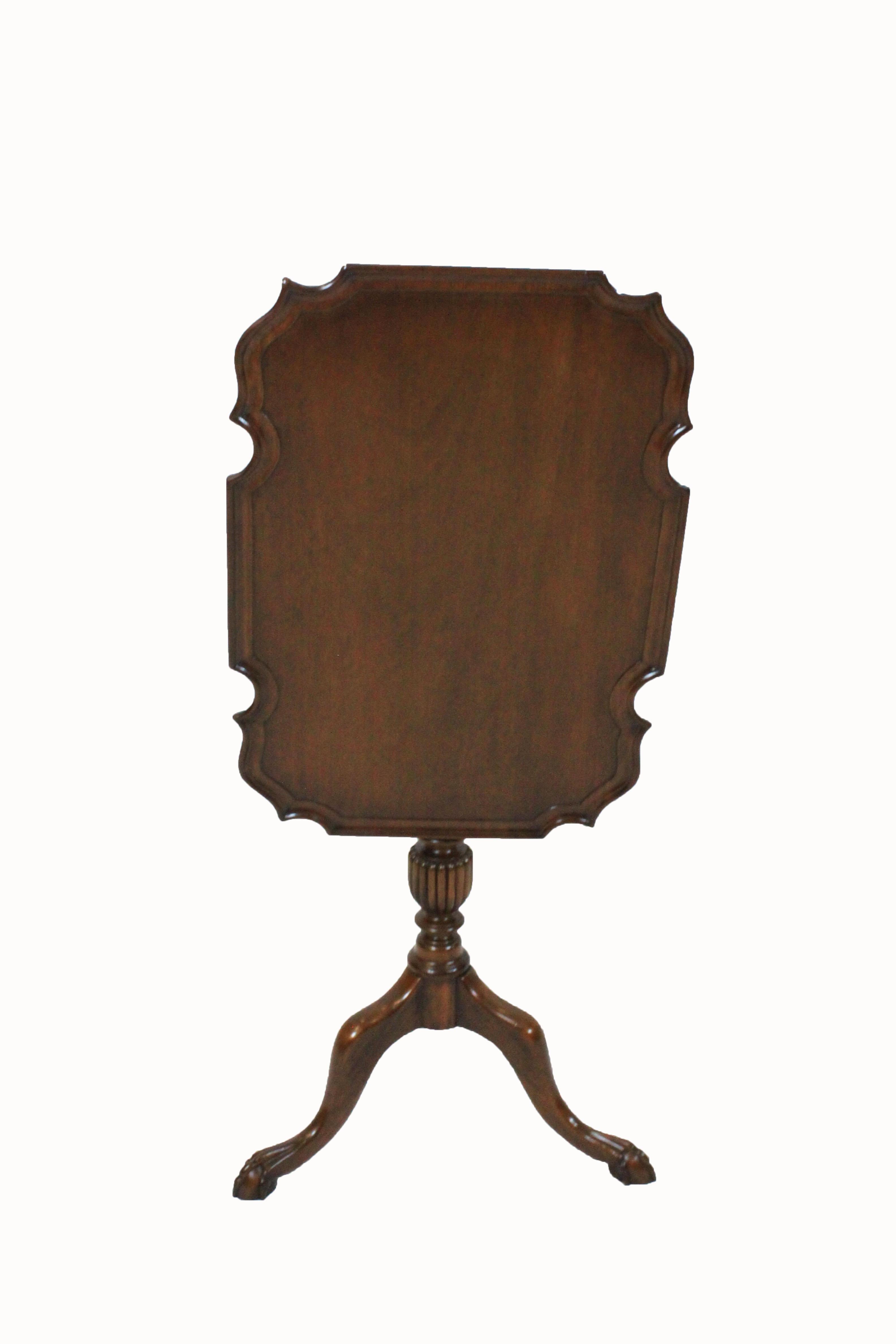 Custom English mahogany Chippendale style tilt-top table with scalloped pie crust top on a turned column with fluted urn supported by cabriole legs ending in ball and claw feet.