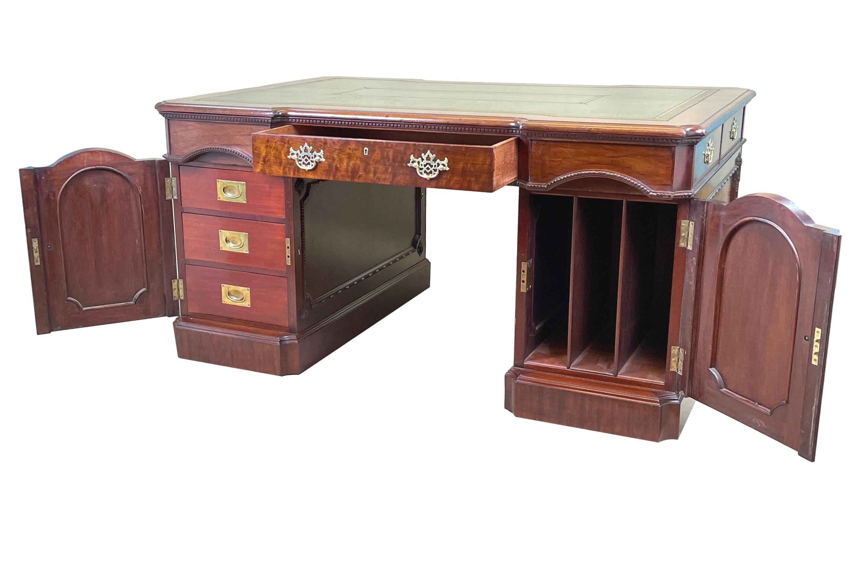 An exceptional quality 19th century, Chippendale style, Walnut pedestal partners desk, of good bold proportion, having gilt tooled inset leather to breakfront top, over various drawers and cupboard doors to front, back and sides, the cupboards