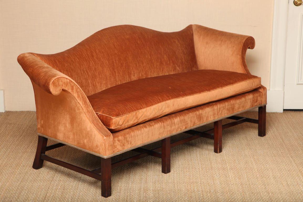 Wonderful Wood & Hogan Chippendale style mahogany sofa with bold scroll arms and accentuated curves on moulded legs with stop flute detail. Bench cushion luxuriously filled with 80% goose down - 20% feather.

Upholstered in a high traditional