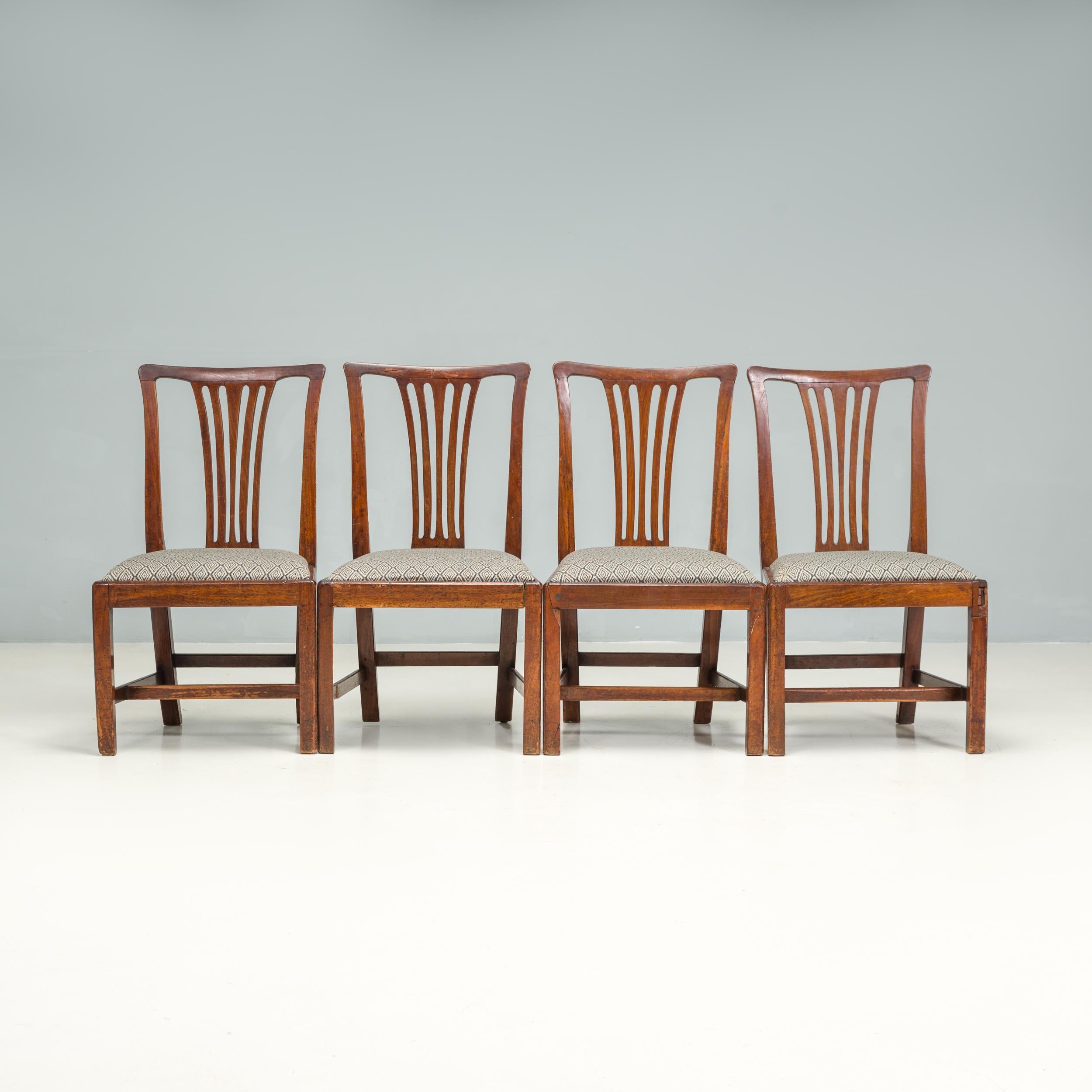 A fantastic set of four Chippendale style dining chairs, beautifully constructed from dark wood.

The chairs feature the classic splat back style, with a decorative pierced fan detail and slightly curved top.

The front legs and stretcher, in