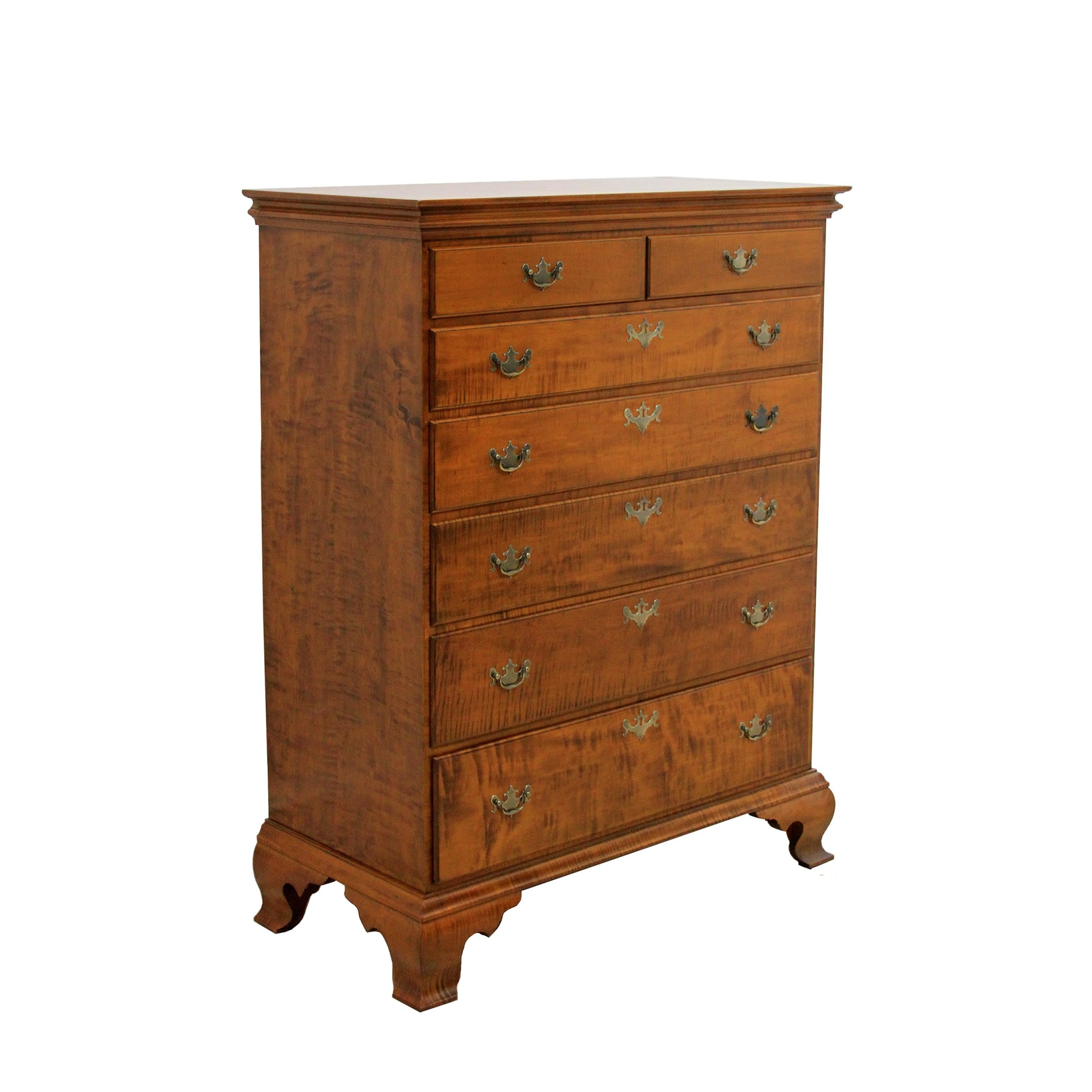 Our Chippendale tiger maple six drawer dresser is shown in our traditional stain with dovetailed drawer cases and top, OG bracket feet and Chippendale brass pulls available polished or antiqued with matching escutcheons. Custom sizes, wood types and