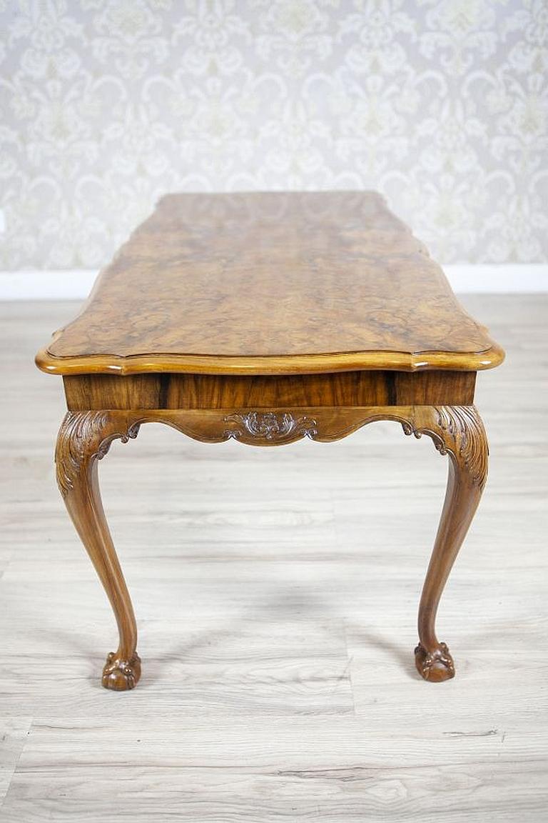 Chippendale Walnut Coffee Table from the Early 20th Century Finished in Shellac

A medium-sized coffee table, circa 1940, in the Chippendale style.
The rectangular top is lined with walnut veneer with a beautiful pattern. The rim is finished with