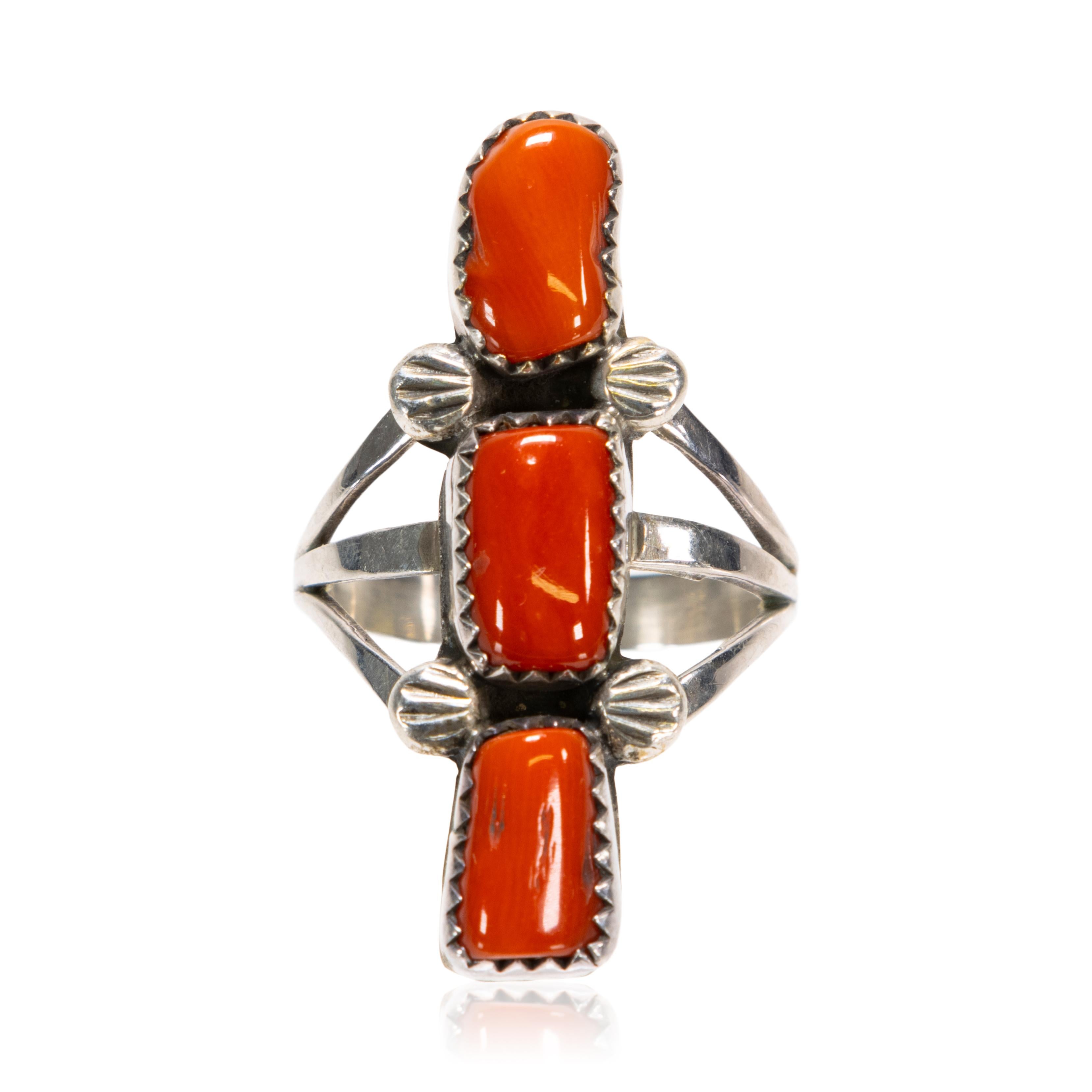 Philip J. Morse Chippewa coral and sterling silver elongated ring. Features three coral cabochon gemstones from the Ojibwe National, specifically the Sault Ste Marie Tribe of the Chippewa Indians. Signed PM Sterling.

PERIOD: Mid 20th