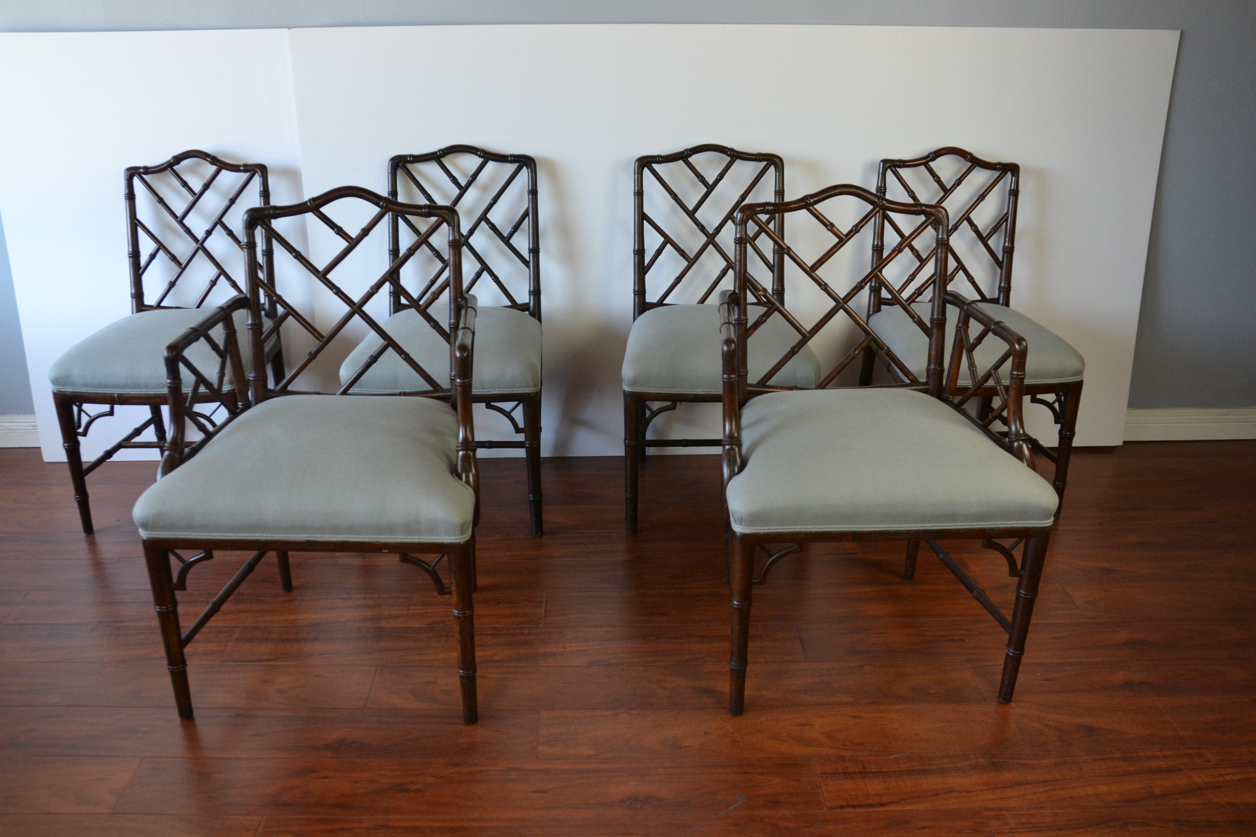 Chinese Chippendale style faux-bamboo dining chairs set of eight. Upholstered in light gray-blue linen. Measures: Armchairs 23.50