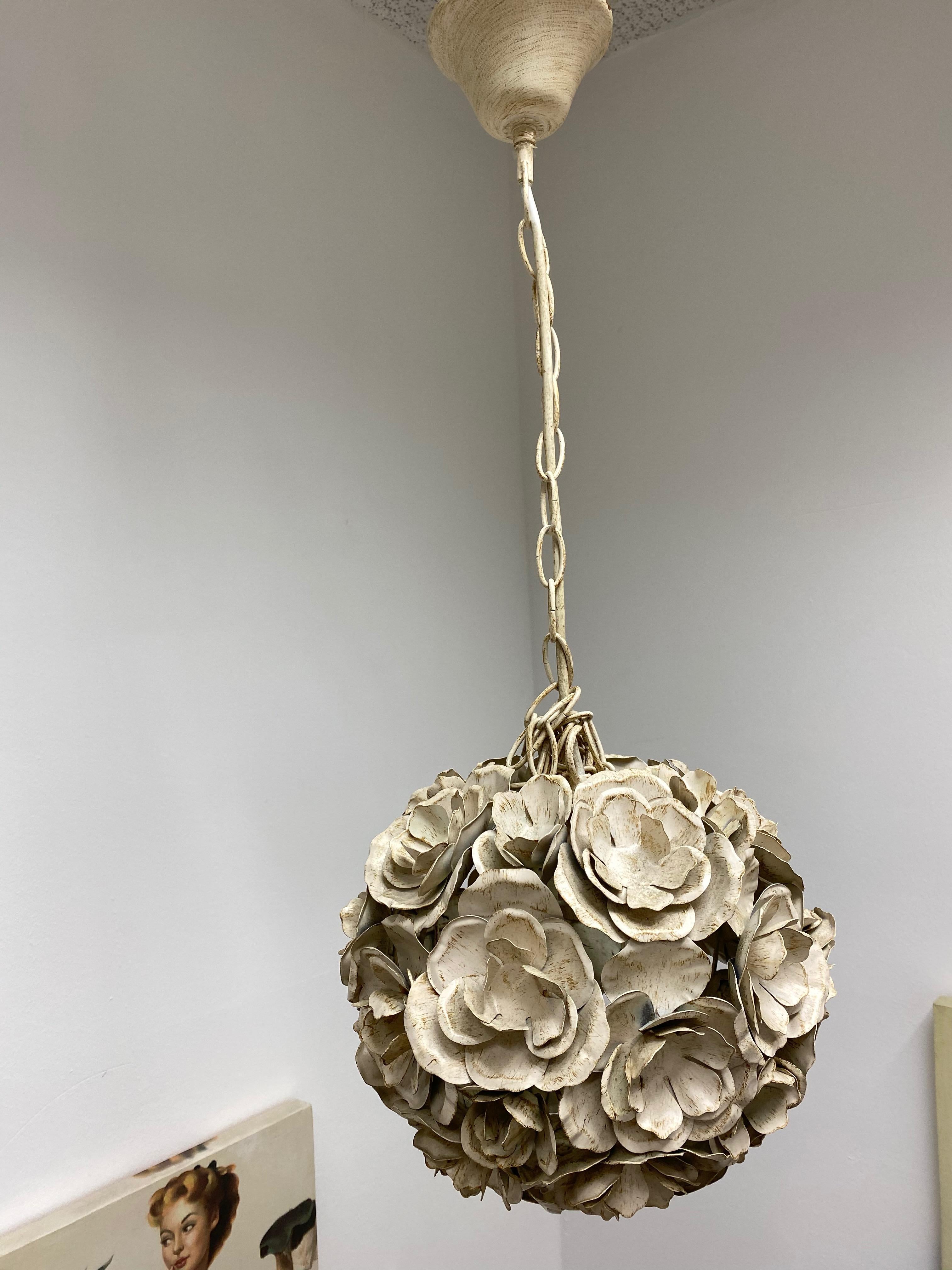 Add a touch of opulence to your home with this charming chandelier! Flowers in the style of a ball, to enhance any chic or eclectic home. We'd love to see it hanging in an entryway as a charming welcome home. The Fixture requires an European E14 /