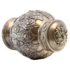 Chiseled and embossed silver pot with garlands, bows, florals, and lid