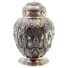 Chiseled and embossed silver pot with garlands, bows, florals, and lid