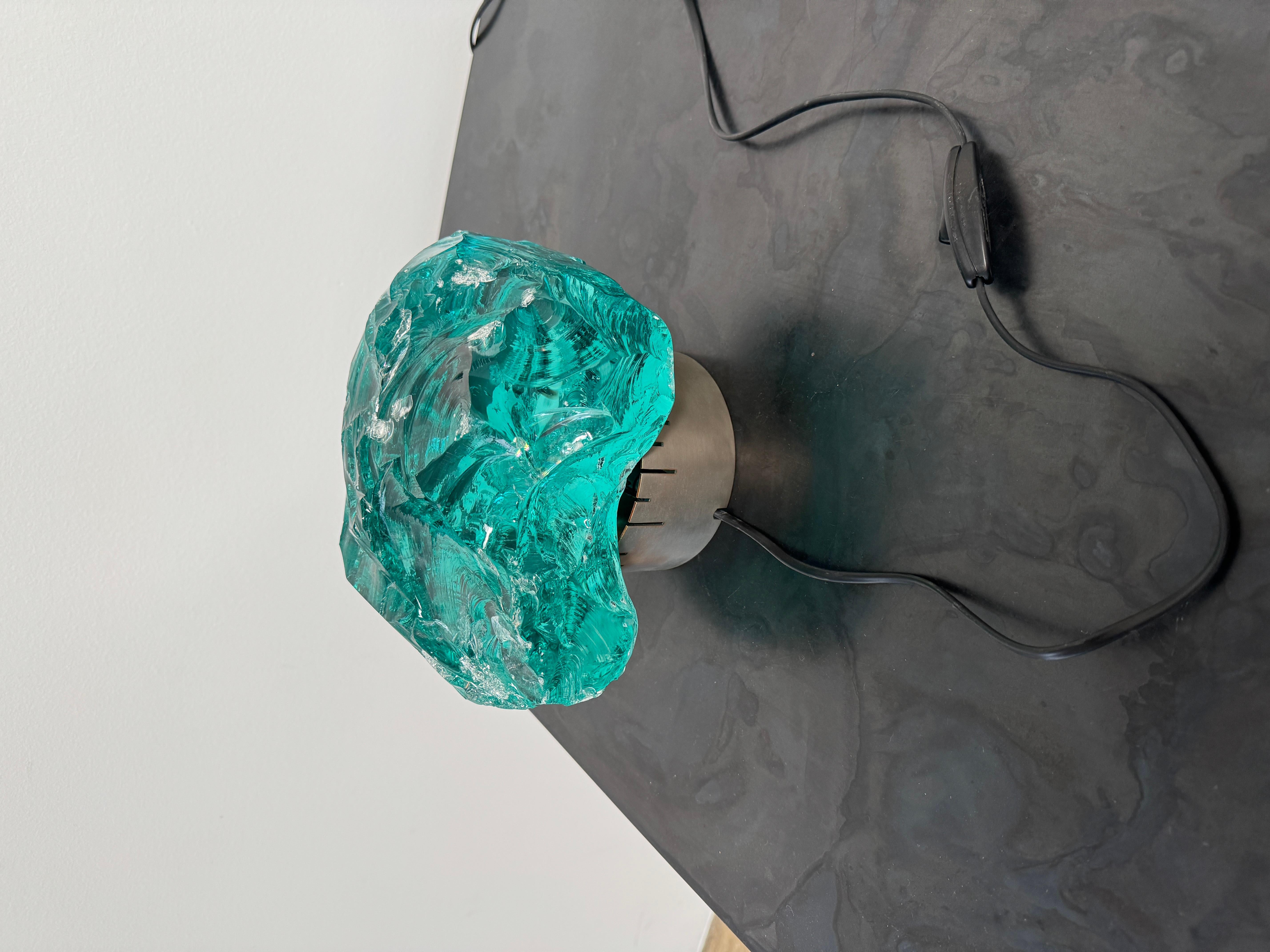 Lámpara de mesa de cristal cincelado de Max Ingrand para la empresa francesa de cristal Saint
Gobain. Cristal de color turquesa que descansa sobre una base circular de latón niquelado cepillado. Marca de fabricante impresa en el borde inferior de la