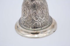 Chiseled silver bell with plant motifs