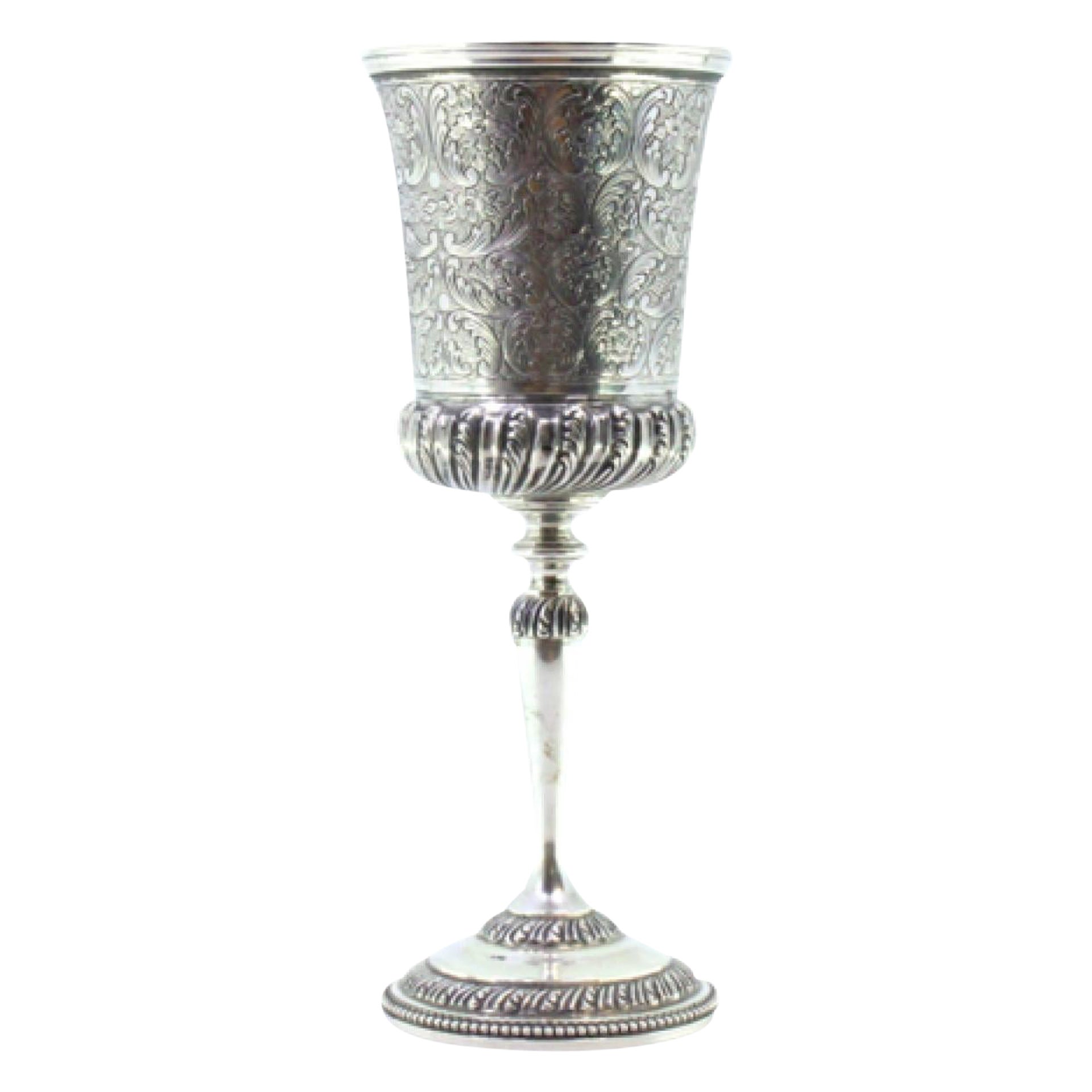 Chiseled silver chalice with reliefs and pearly-frieze base