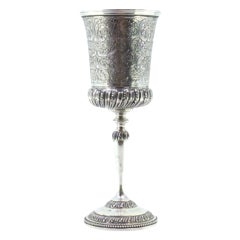 Chiseled silver chalice with reliefs and pearly-frieze base