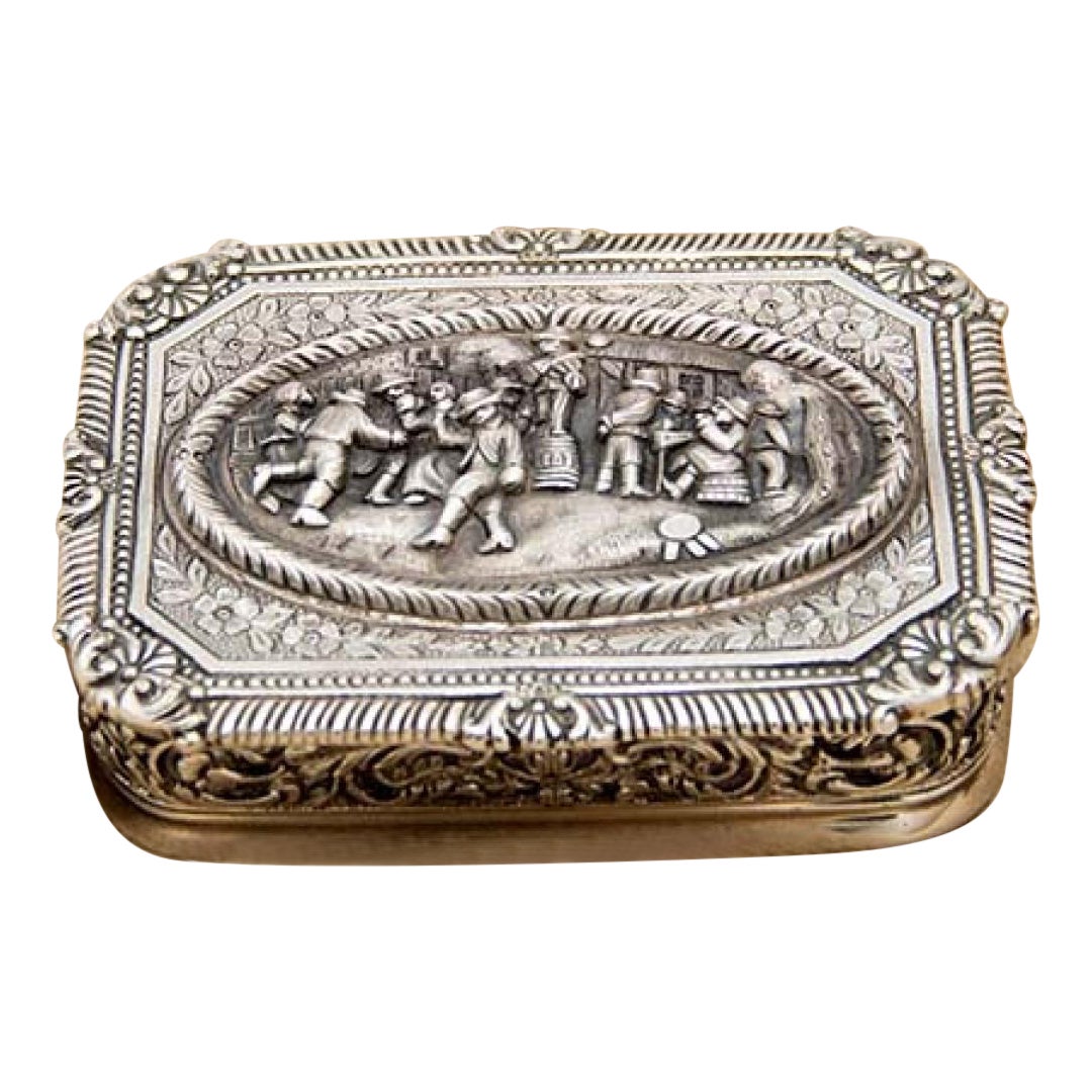 Chiseled silver city-allegory jewelry box with floral motifs and gold interior