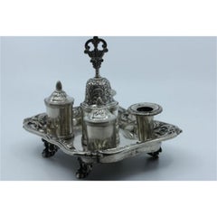 Chiseled silver inkwell with bell, two reservoirs & four relief feet