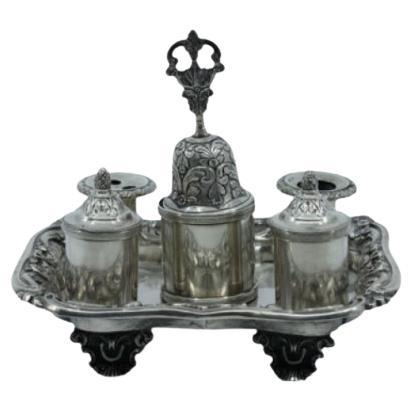 Chiseled silver inkwell with bell, two reservoirs 
four relief feet