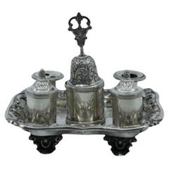 Chiseled silver inkwell with bell, two reservoirs 
four relief feet