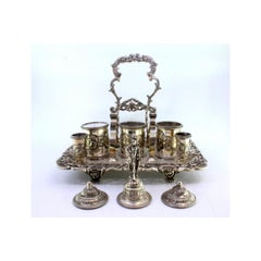 Chiseled silver inkwell with cut-out tray, three tanks, bell & claw feet