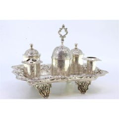 Chiseled silver inkwell with two pen holders, tanks, bell & floral feet