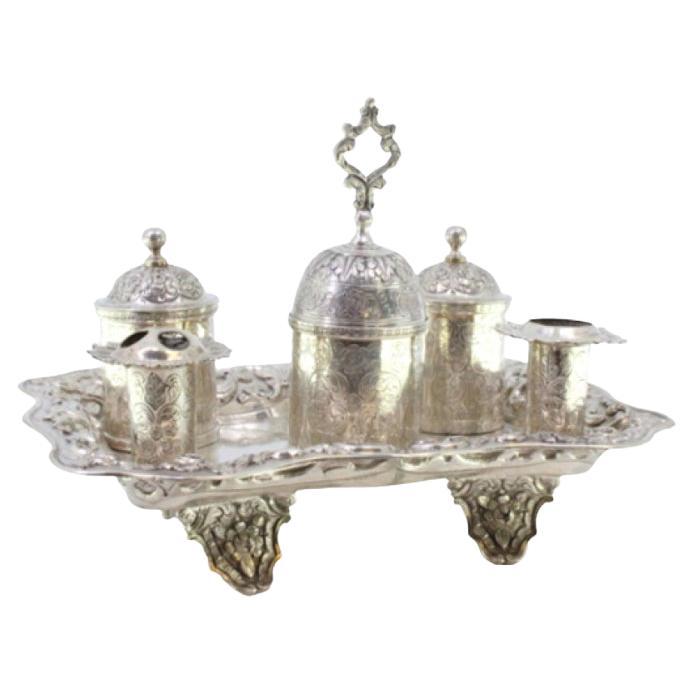 Chiseled silver inkwell with two pen holders, tanks, bell 
floral feet