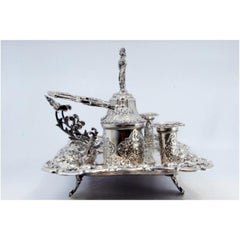 Chiseled silver inkwell with two pen holders, two tanks & bell
