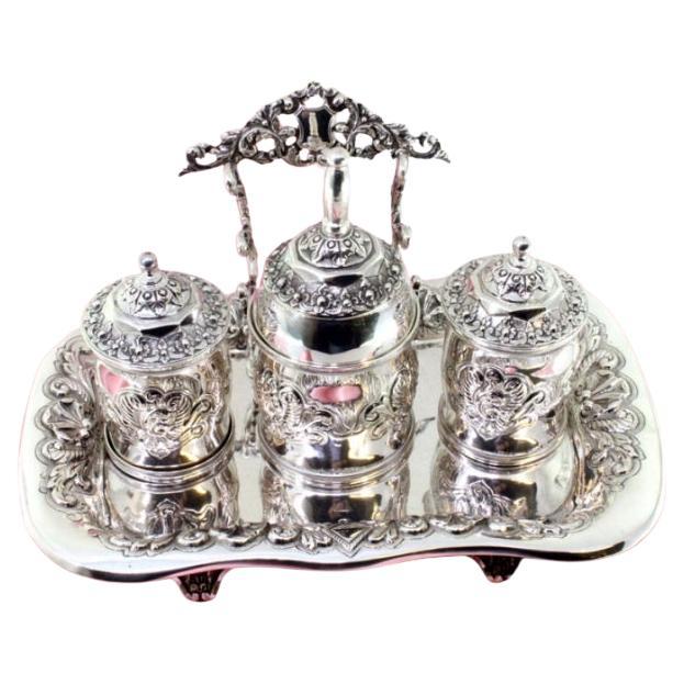 Chiseled silver inkwell with two tanks, bell 
four hollow feet