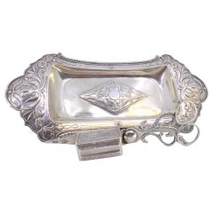 Chiseled silver tray
scissors w/ florals, friezes
4 ball feet
