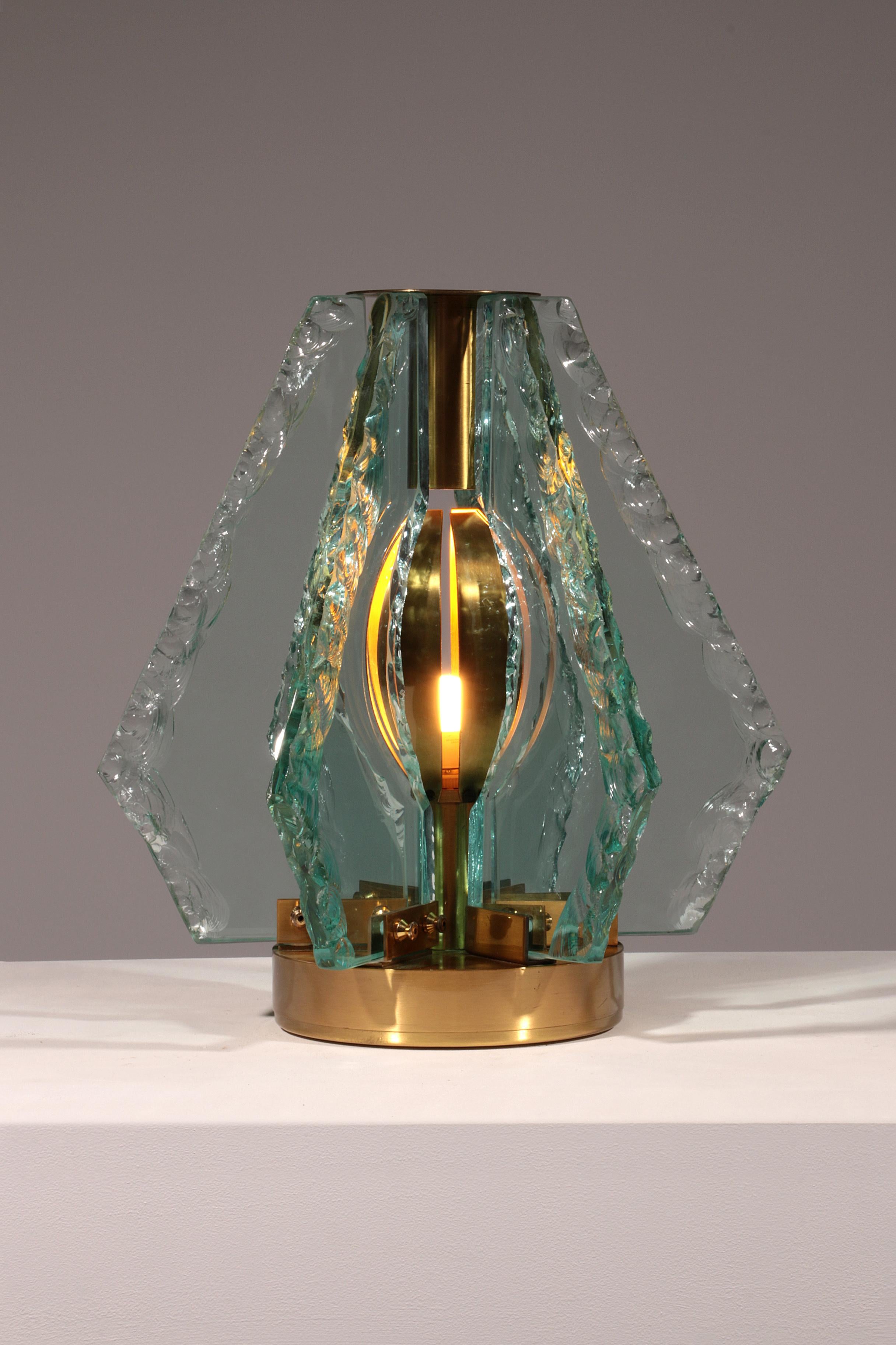 Step into the elegance of Italian mid-century design with this rare and extravagant Chiselled Glass Table Lamp in Brass, crafted in the 1960s by the renowned Gino Paroldo for Dinodei. A true collector’s piece, this lamp embodies the refined luxury