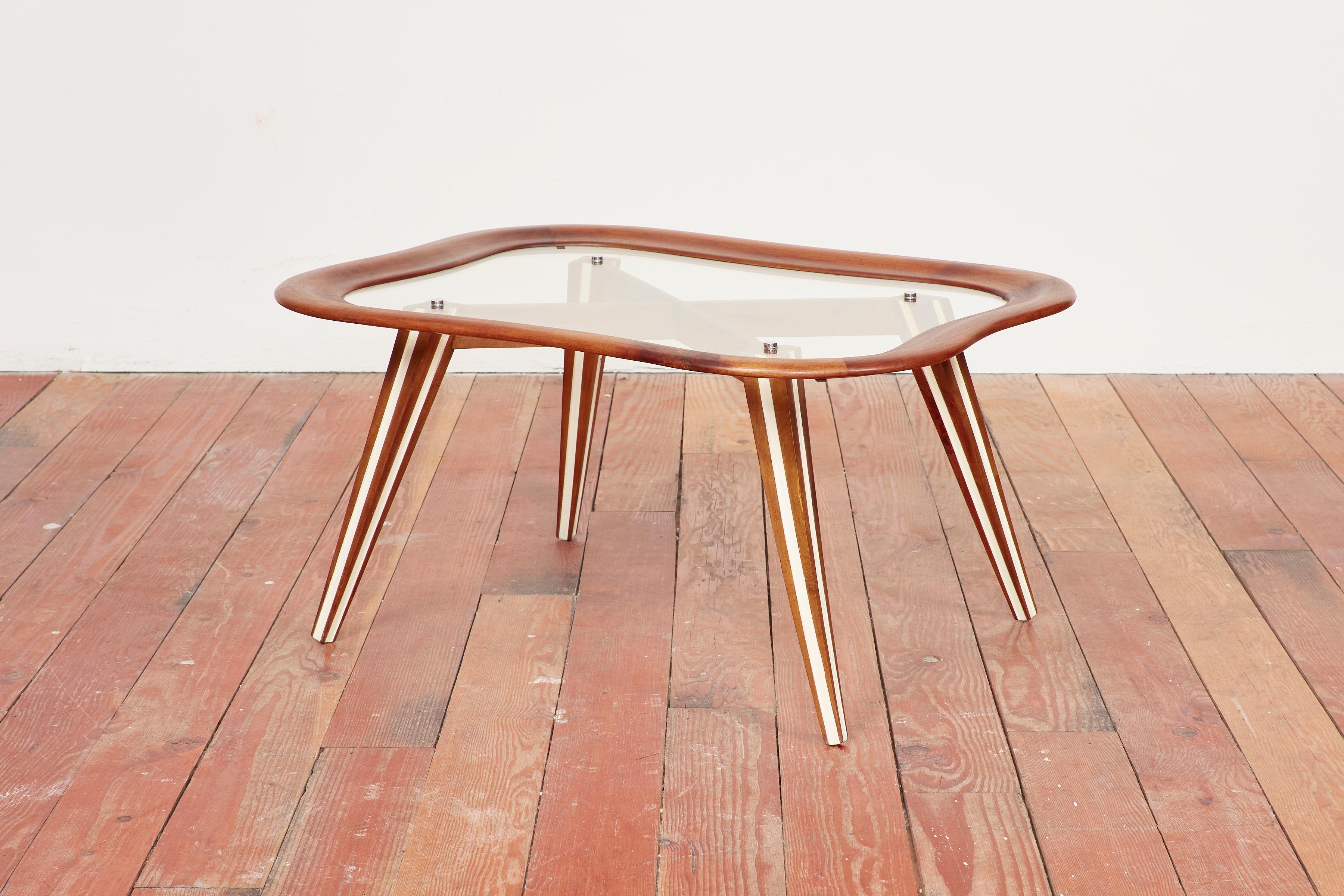 Italian side table by designer Chrissotti Filippo 
Amoeba shaped glass with wood frame and angular legs
Brass accents.
Excellent piece.