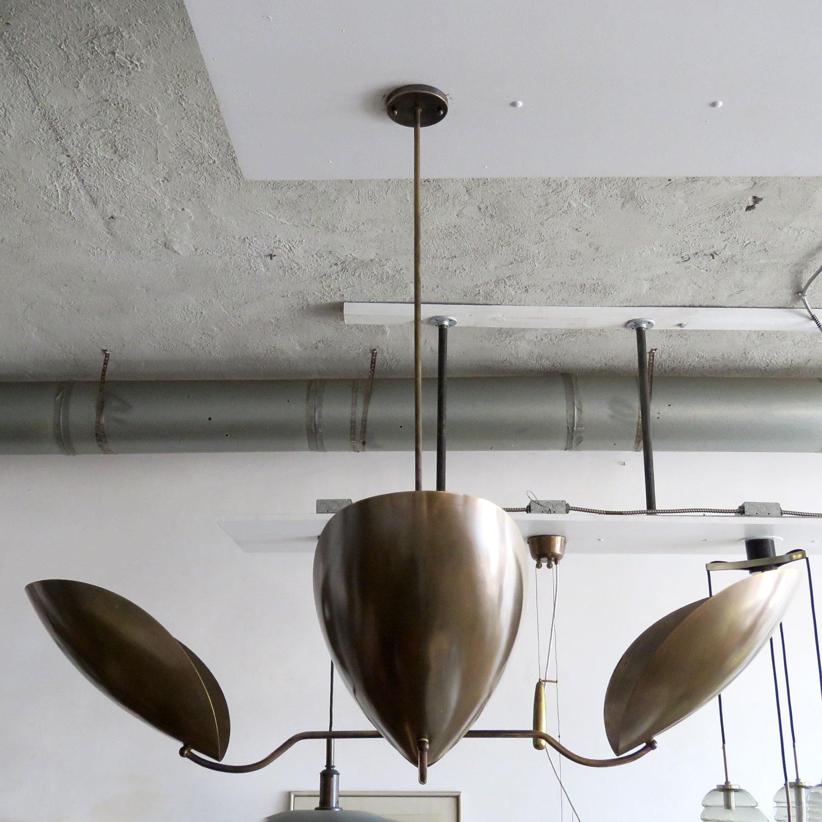 Elegant four shield chandelier 'Chiton-4' designed by Gallery L7, handcrafted and finished in Los Angeles from American aged raw brass, overall height can be customized ( 20in + ). Four E26 sockets per fixture, max. wattage 60w each or 3-7w LED