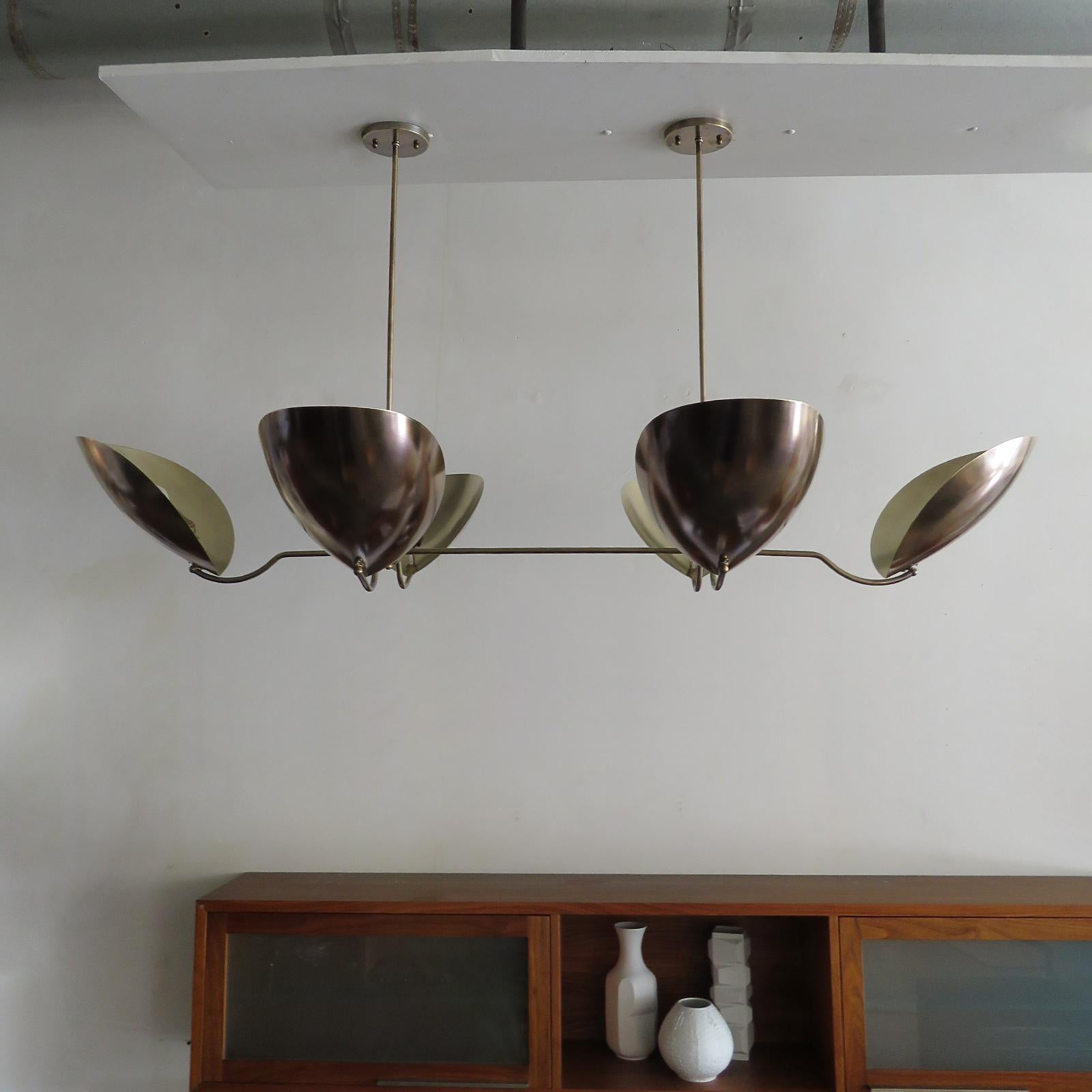 Elegant Chiton-6 chandelier, designed by Gallery L7, handcrafted and finished in Los Angeles from American brass. Reminiscent of stag beetle armor, in an aged raw brass finish, overall height can be customized. Six E26 sockets per fixture, max.