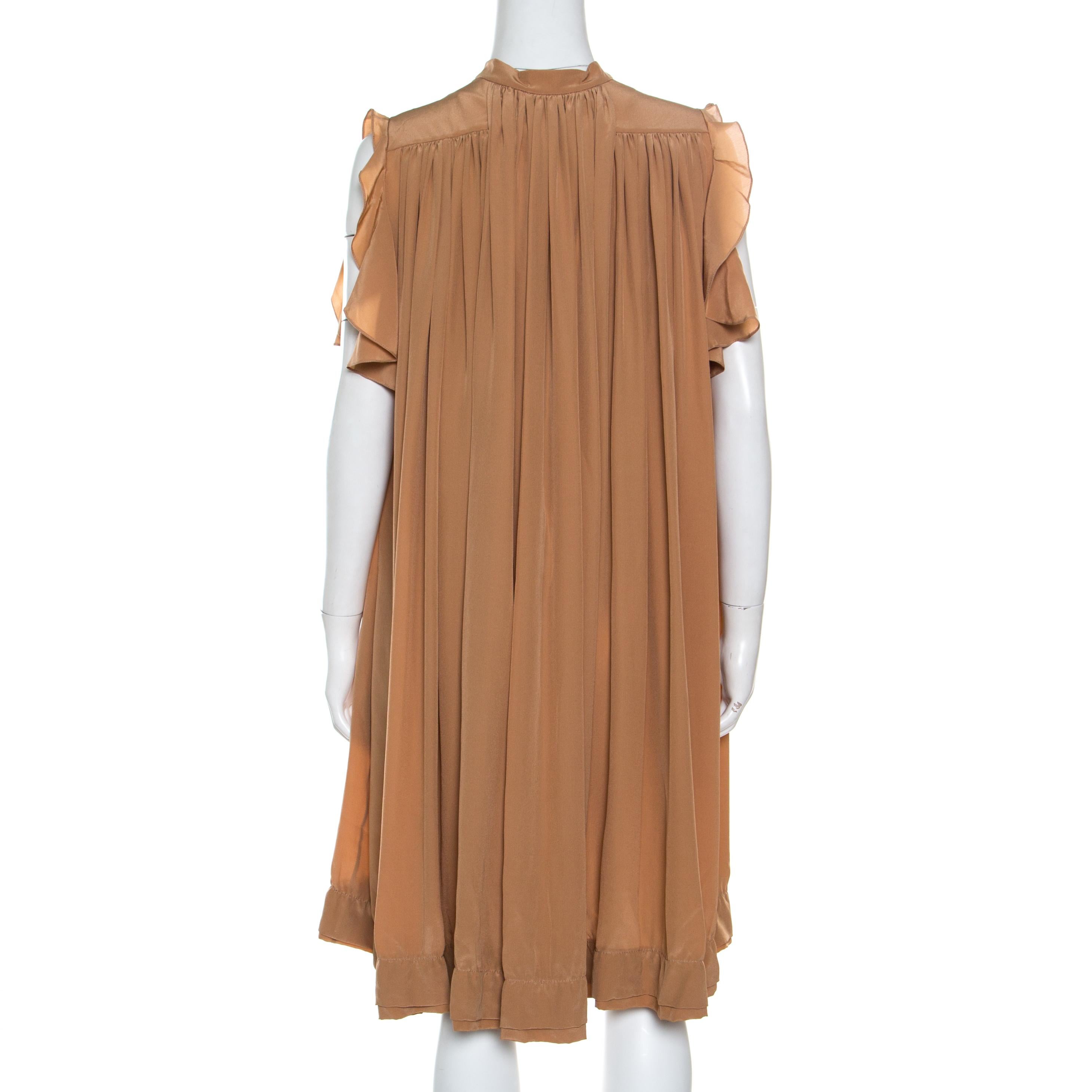 This modernistic dress from the house of Chloe features a pretty design making it a must-have piece in your closet. Arrive in great style dressed in this charming brown dress. Crafted with smooth silk fabric this dress puts you in the limelight. It