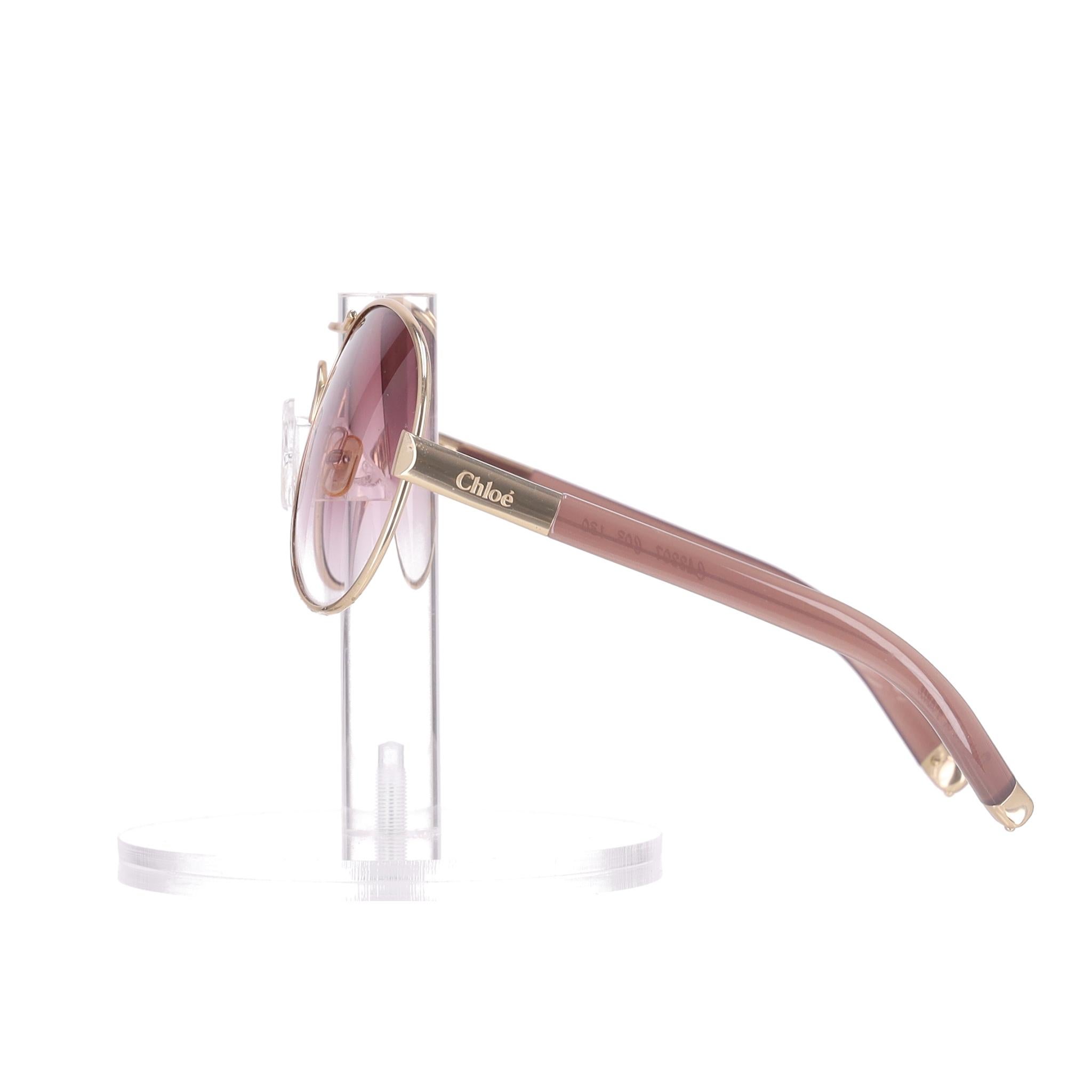Chloe Aviator Sunglasses

Gold metal framed aviator sunglasses with pink gradient lenses.

Dusty pink thin arms with gold temple tips and 'Chloe' engraved accents to the sides.

Providing 100% UV protection.

Rrp Approx. £250

Size – One