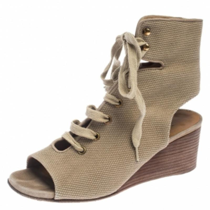 A perfect mix of elegant fashion and comfortable style, these Chloe sandals come crafted from canvas and detailed with lace-ups and open counters. They're visually stunning and they stand tall on wedge heels.
