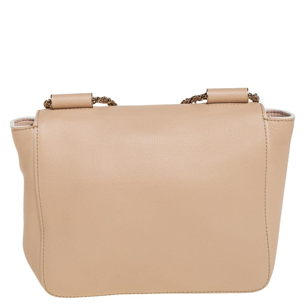 Every curve and detail on this Chloé Elsie is grand which adds to the worth of the bag. It has been crafted from leather and styled with a flap. The bag is secured by a turn-lock revealing a well-sized interior and completed with a shoulder strap
