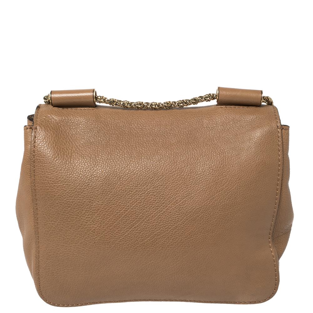 Every curve and detail on this Chloé Elsie is grand which adds to the worth of the bag. It has been crafted from leather and styled with a flap. The bag is secured by a turn-lock revealing a well-sized interior and completed with a slender shoulder