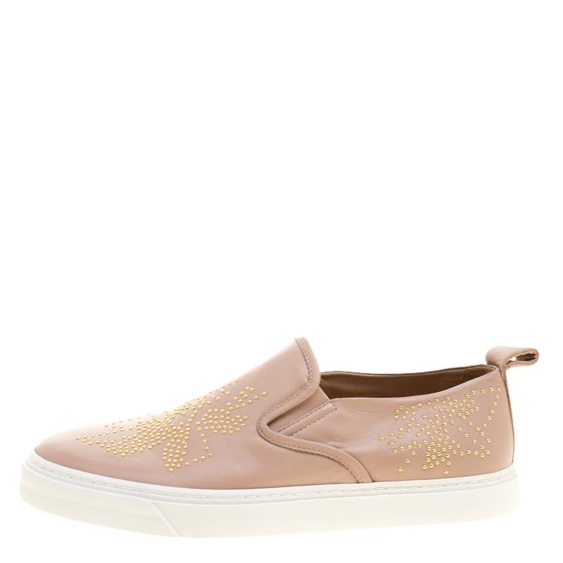 Flaunt your high-style with these trendy sneakers from Chloe! They've been carefully crafted from beige leather, and designed in a slip-on style with stud embellishments on the exterior. You are sure to receive both comfort and fashion when you