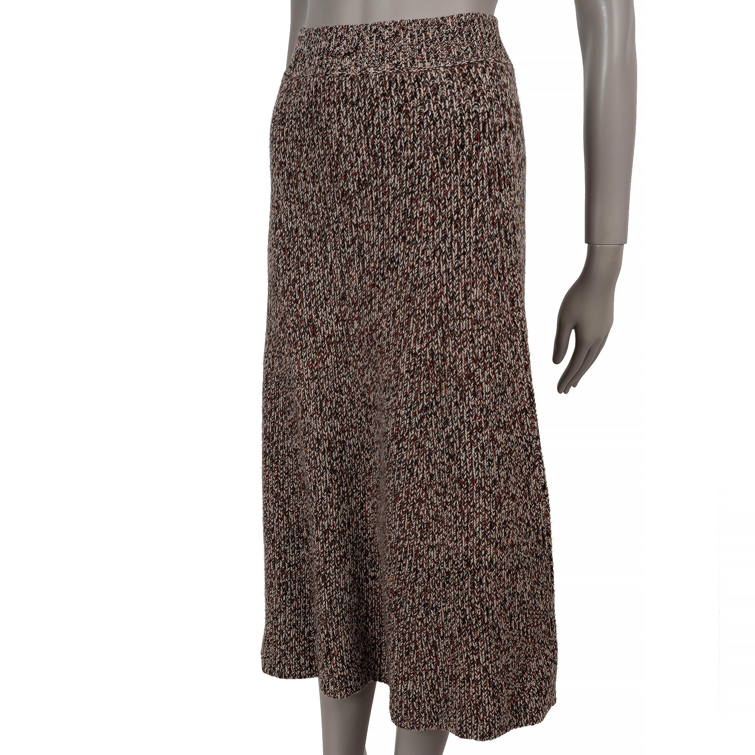 This 100% authentic Chloé skirt in rust, brown, and beige mélange cashmere (69%) and wool (31%) exudes effortless elegance. Designed with a flared silhouette and midi length, it features a rib-knit waist for a comfortable fit. Slip-on style and
