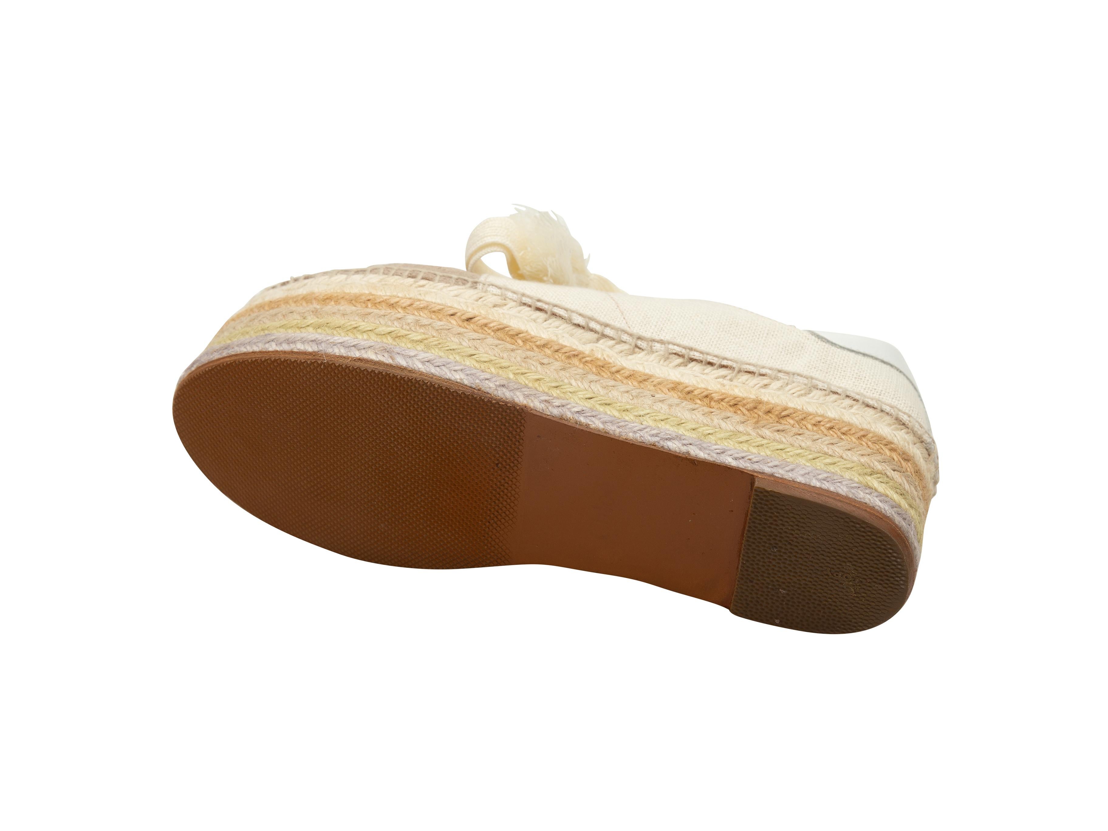 Product details: Beige and taupe jute and suede flatform espadrilles by Chloe. Jute trim at rubber soles. Lace-up tie closures at tops. Designer size 41. 2.5