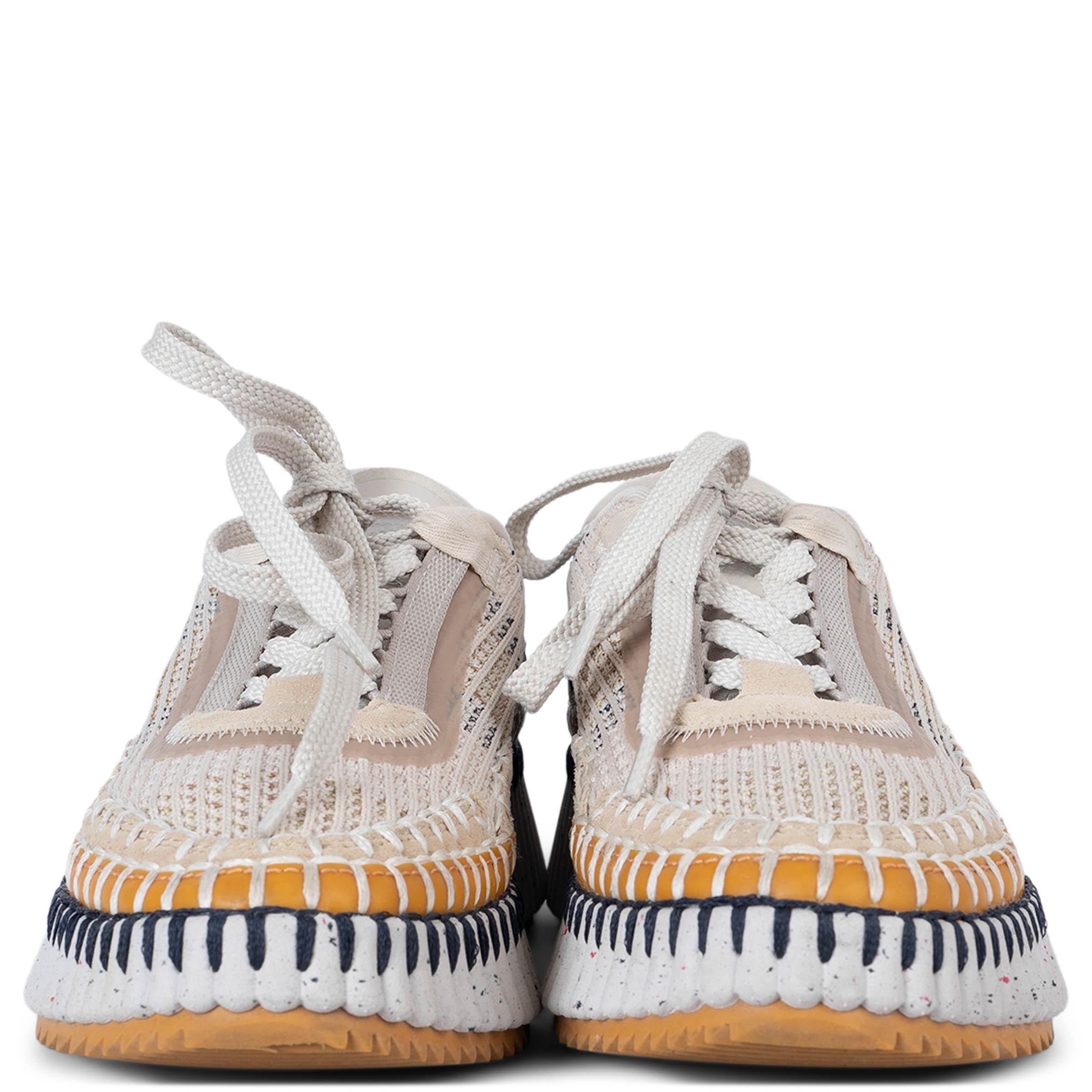 100% authentic Chloé Nama sneakers in light beige suede and beige, off-white and navy blue recycled mesh. Features chunky, ribbed rubber platform soles, logo embossing in the back and hand stitched details in white and navy blue on mustard rubber