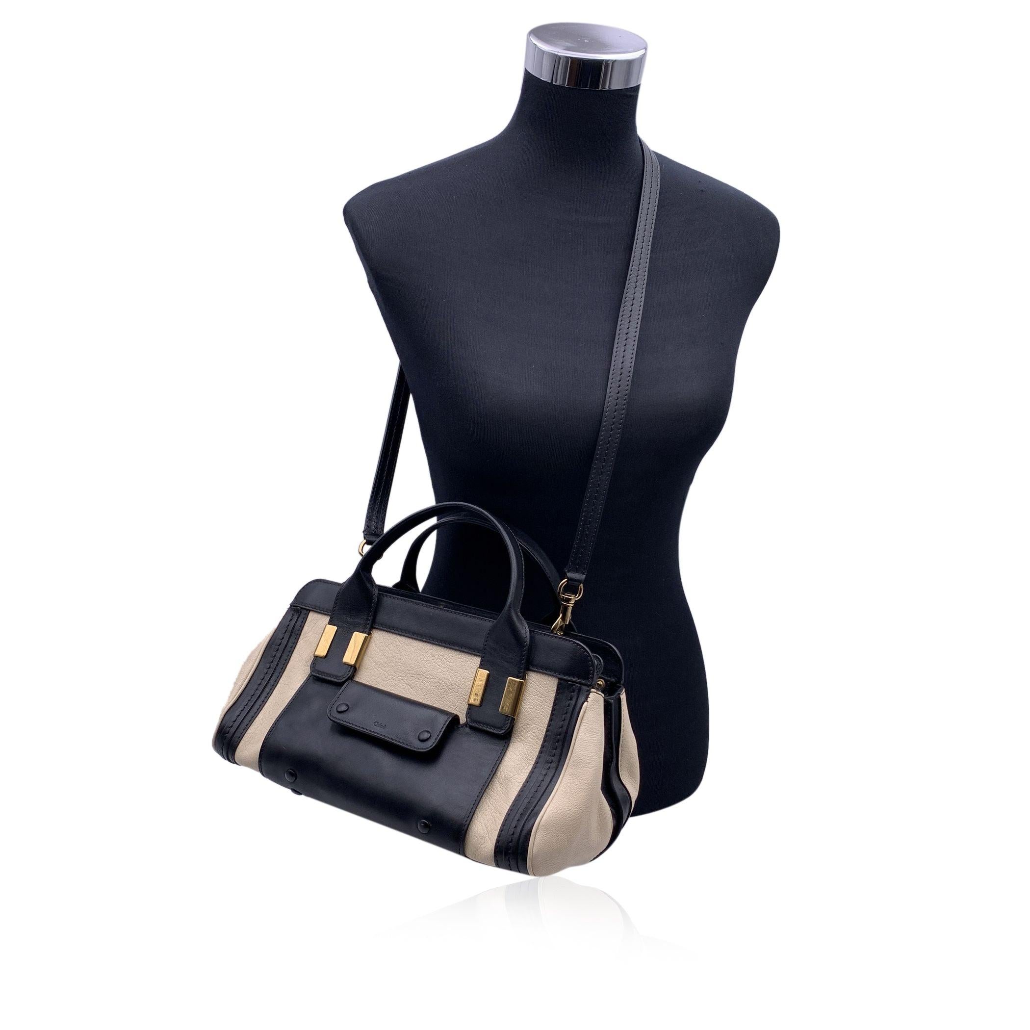 Gorgeous CHLOE small 'Alice' bag crafted in genuine white and black leather. This bag features two leather handles and removable shoulder strap. Open pocket and Flap pocket with button closure on the front. Upper zipper closure. Black fabric lining.