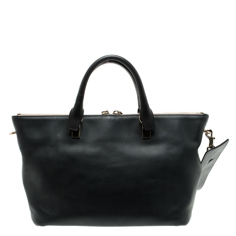 Make everyone nod in approval when you step out swaying this Baylee tote from Chloe. It has been crafted from leather and styled with gold-tone hardware. The tote has a top with a chain connecting two zippers and it opens to a spacious fabric