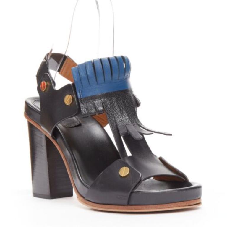 CHLOE black blue fringe detail gold nail grommet block heel sandal EU37
Reference: NKLL/A00121
Brand: Chloe
Material: Leather
Color: Black, Blue
Pattern: Solid
Closure: Slingback
Extra Details: Elasticated sling back strap.
Made in: