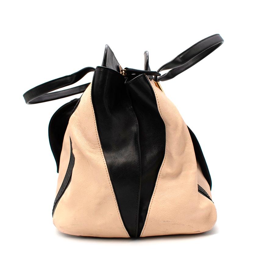 Chloe Black & White Leather Alice Tote Bag
 

 - Bicolour itineration of the Alice tote, featuring a cream body with black base, handles and trim 
 - 2 rolled leather top handles
 - Zip top
 - Front flapped patch pocket
 - Double push gold tone stud