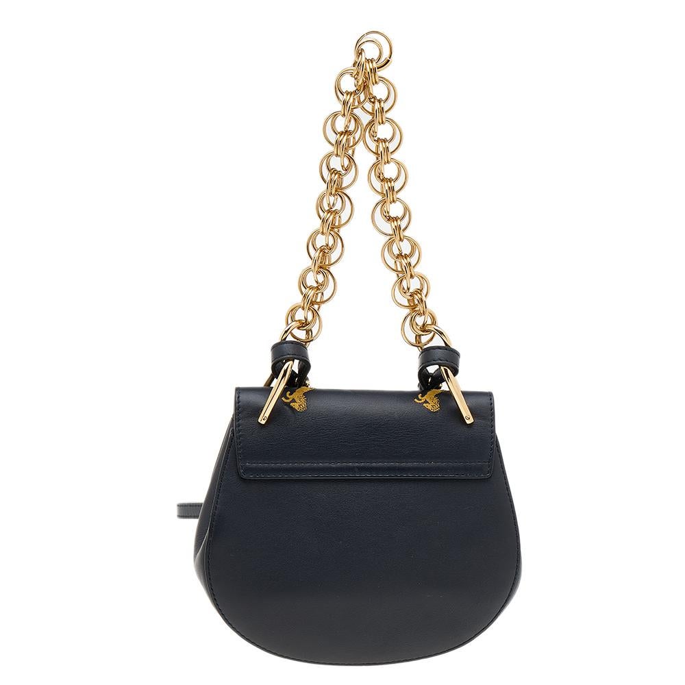This Chloe crossbody bag carries a distinct shape and eye-catching design. It has been meticulously crafted from leather that is embroidered with horses and designed with a pin lock closure and a shoulder chain strap. The amazing black creation is